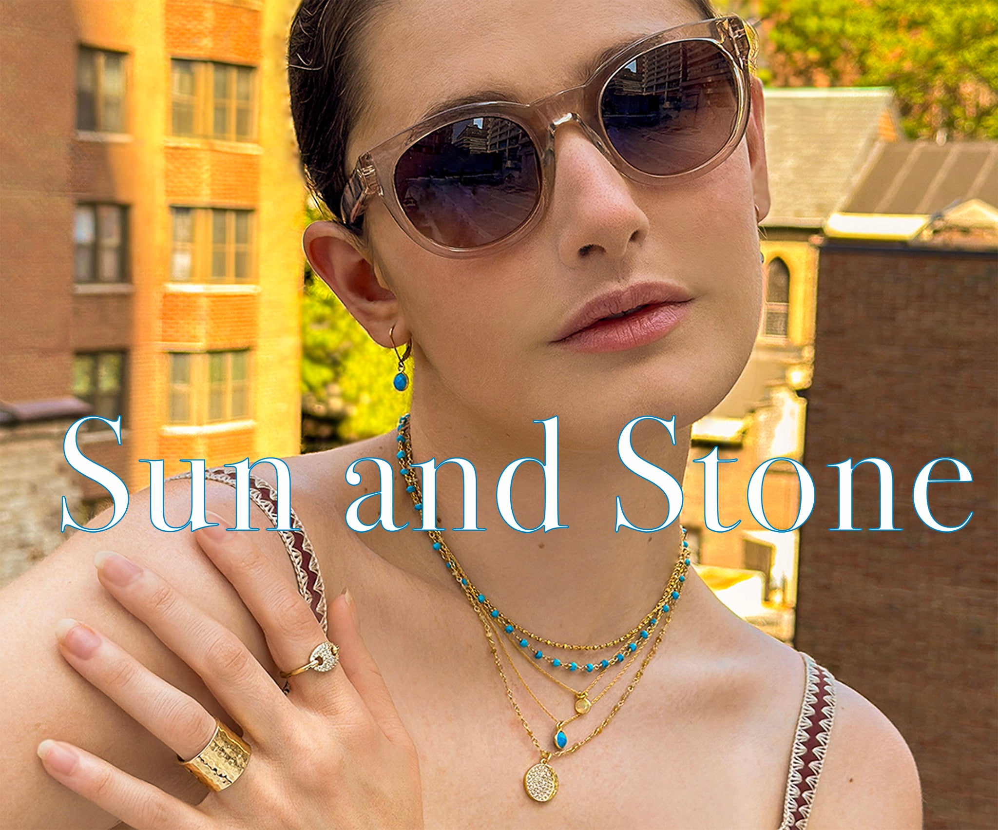 Sun and Stone summer edit banner featuring a model wearing layered pieces in gold, turquoise, and opal, linking to collection page