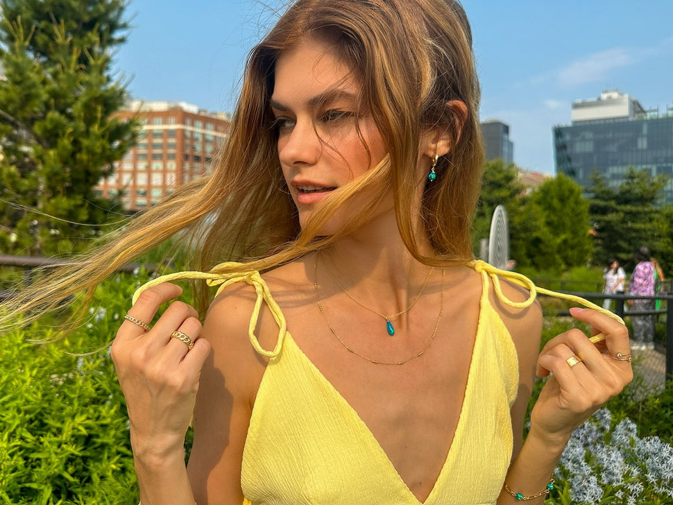 Model wearing Cynthia Rybakoff gold and turquoise jewelry in New York City