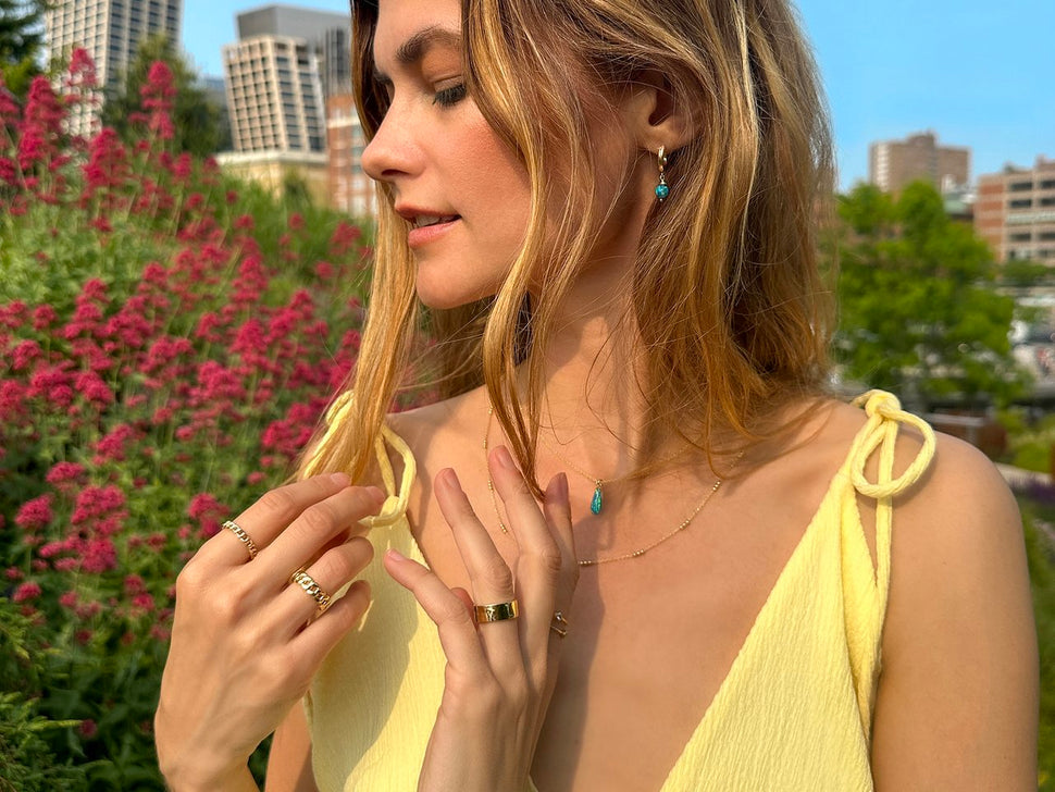 Model wearing Cynthia Rybakoff gold and turquoise jewelry in New York City
